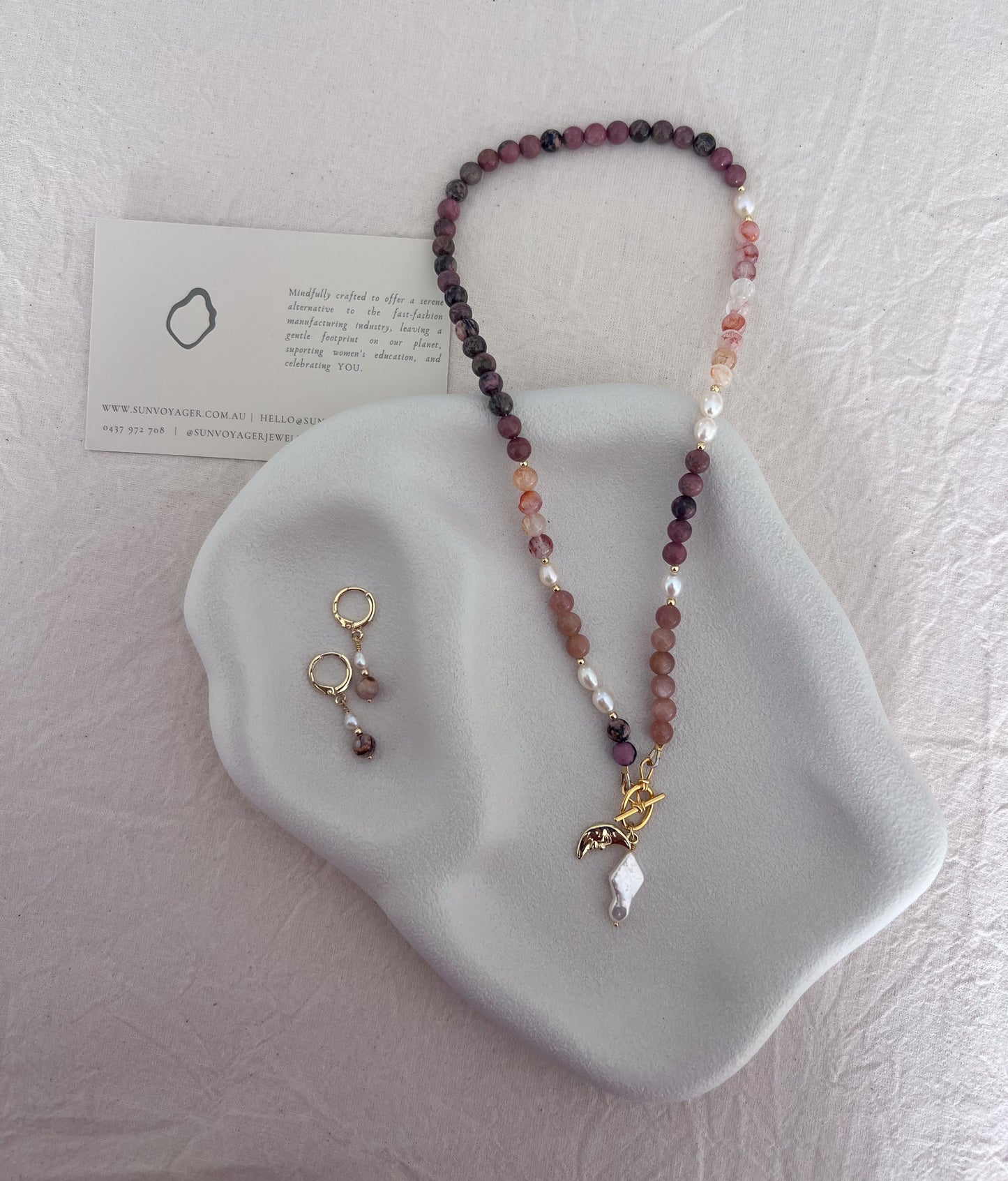 Handmade red quartz, rhodolite and sunstone gemstone necklace with freshwater pearls and an 18k gold-filled front toggle clasp.