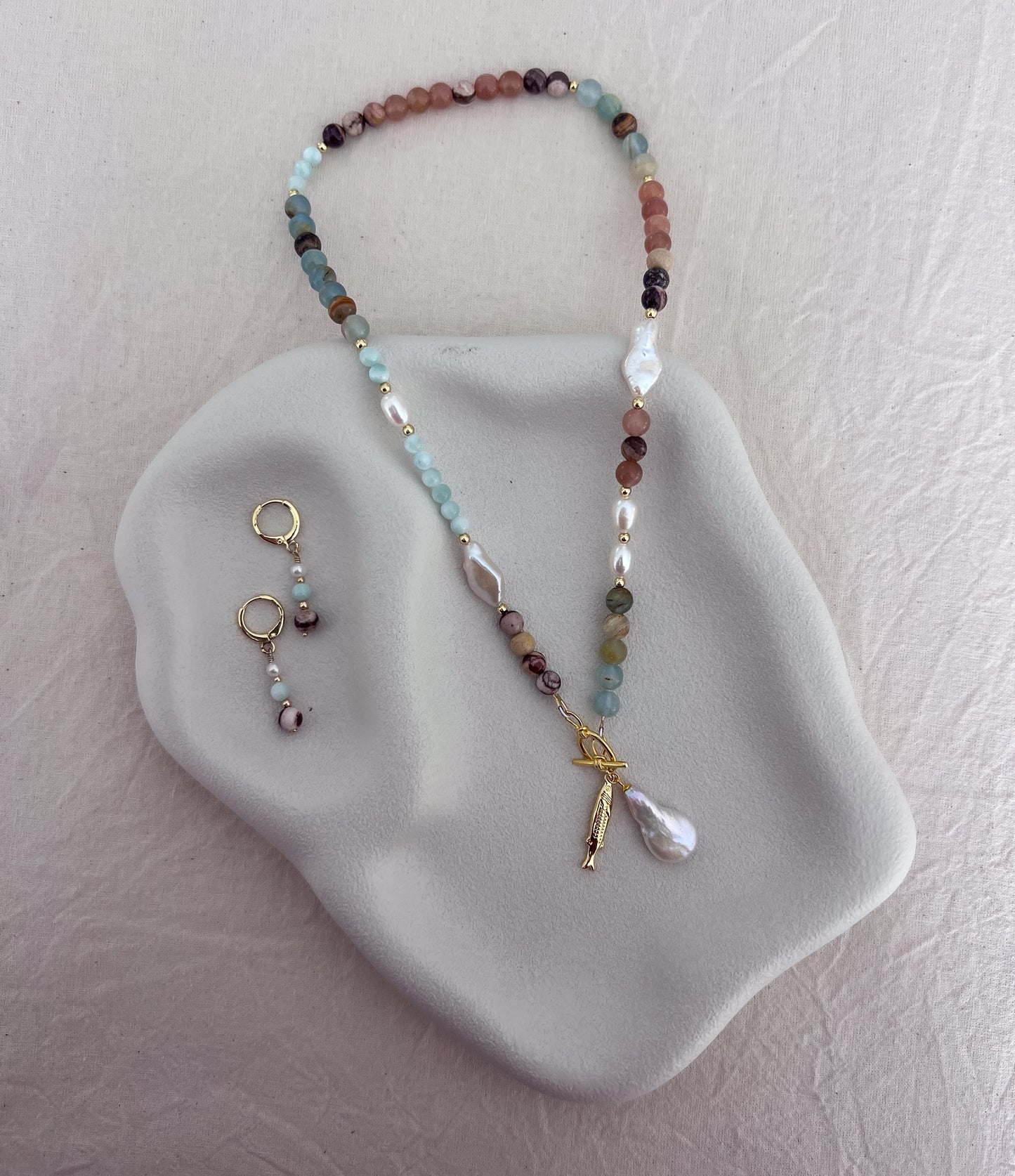Handmade blue calcite, angelite and natural zebra jasper gemstone necklace with freshwater pearls and an 18k gold-filled toggle clasp.
