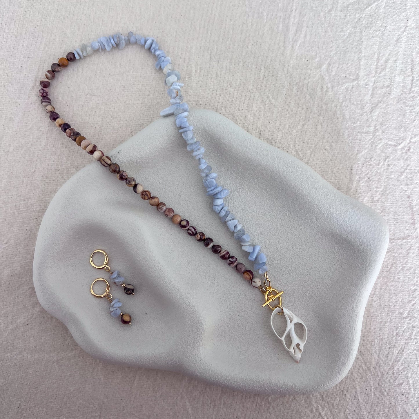 One-of-a-kind blue lace agate and zebra jasper necklace with natural sliced shell pendant and matching gemstone earrings by SunVoyager Jewellery.