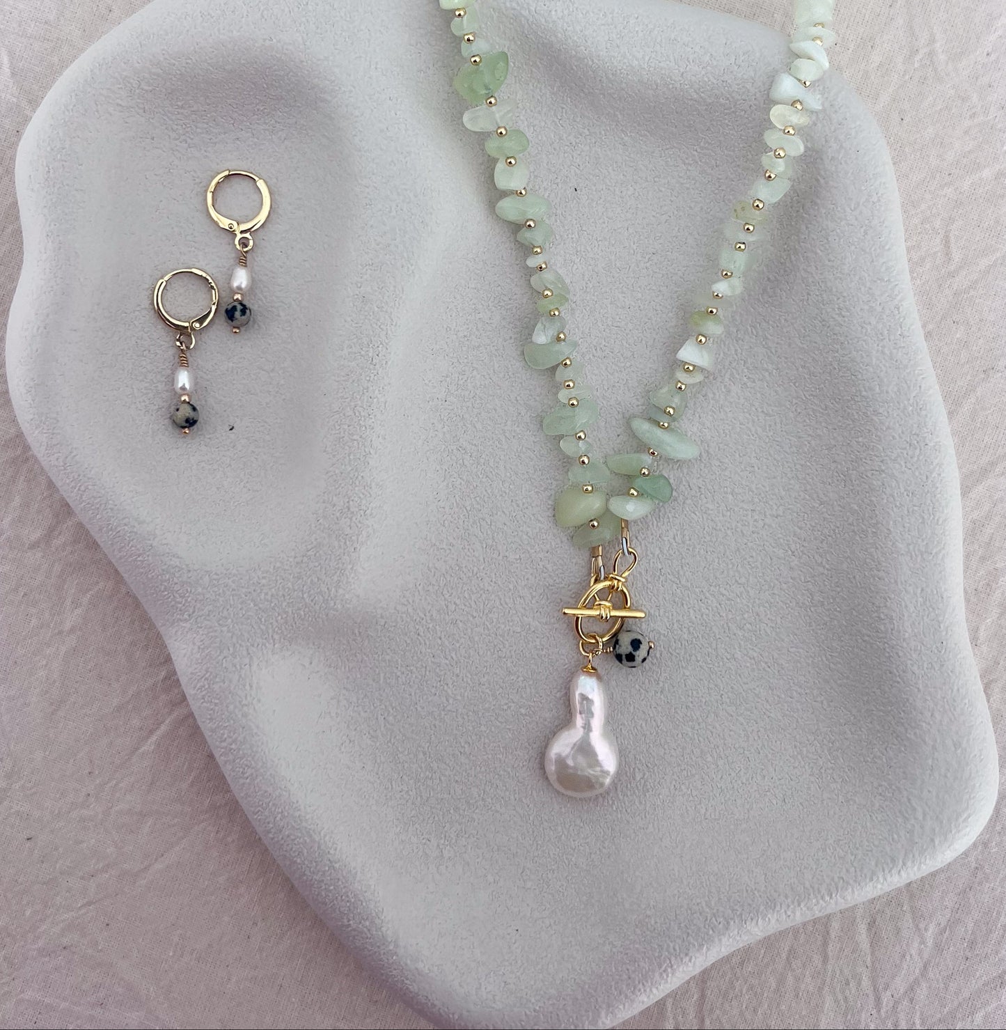Handmade natural jade gemstone necklace with gold-filled beads, front toggle clasp, baroque pearl and Dalmatian stone detail.
