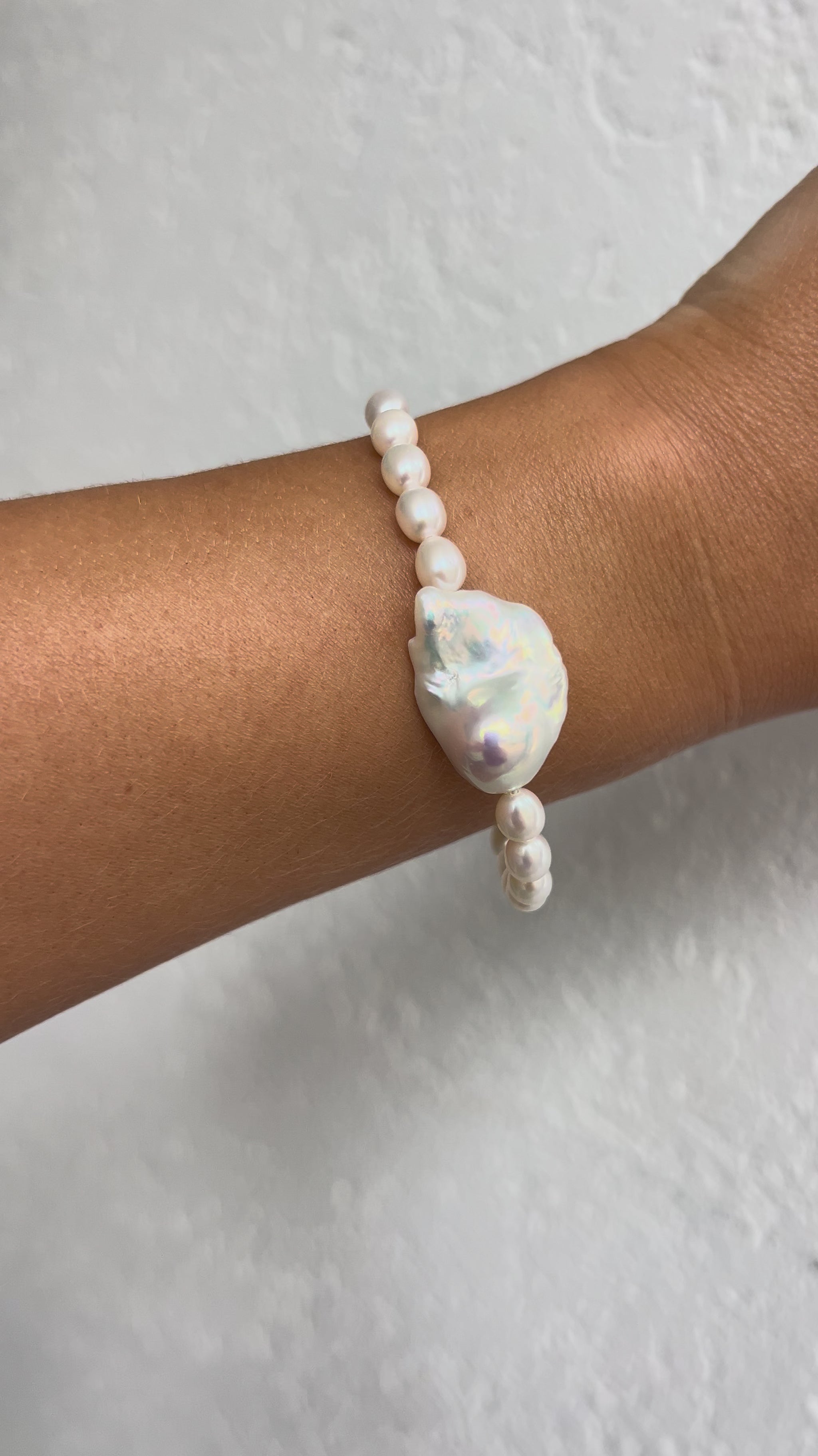 Freshwater pearl bracelet with gold filled toggle clasp and centred baroque freshwater pearl, laid on a sea urchin shell — Solstice Bracelet from the SunVoyager Solstice Collection, made in Tropical North Queensland, Australia.