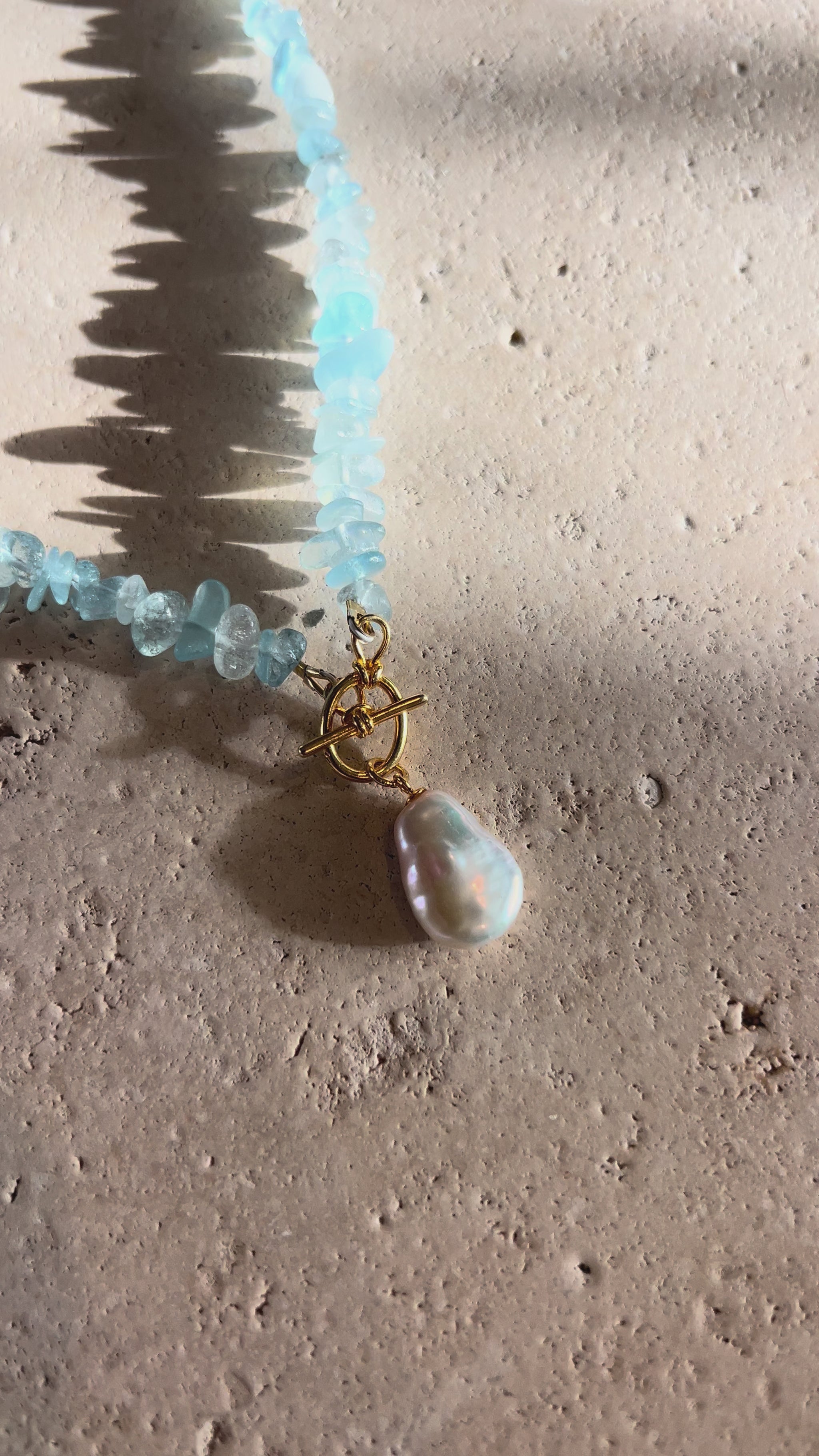 Video of aquamarine gemstone necklace with large gold clasp